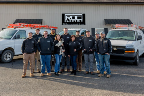 roc electric team in front of building