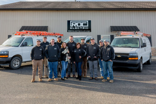 roc electric team in front of building