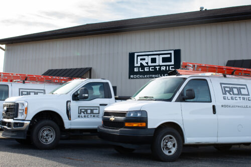 roc electric truck and van in front of building