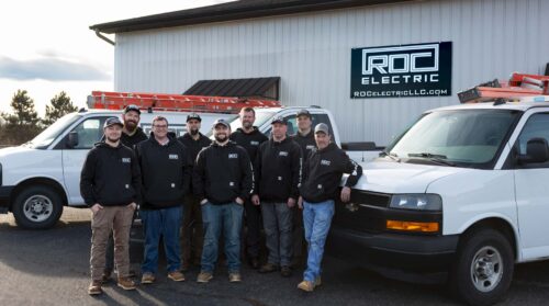 roc electric team outside building with trucks