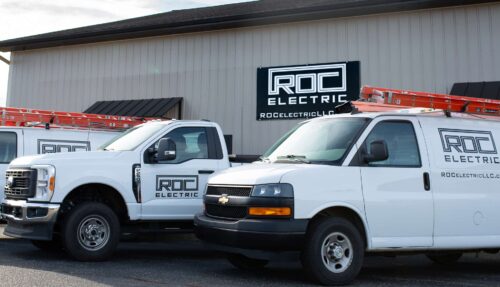 roc electric company building with vehicles in front